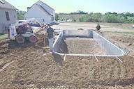 The pool is backfilled in preparation for the concrete walkway.