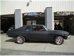 1973 CHEVY NOVA WITH AMERICAN RACING TORQ THRUST WHEELS AND ADDED SOME BEEF ON THE REAR END WITH 295 50 R15 TIRES.