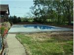 Concrete deck is finished and pool is ready for landscaping. This is eighth working day of construction after several days of rain.